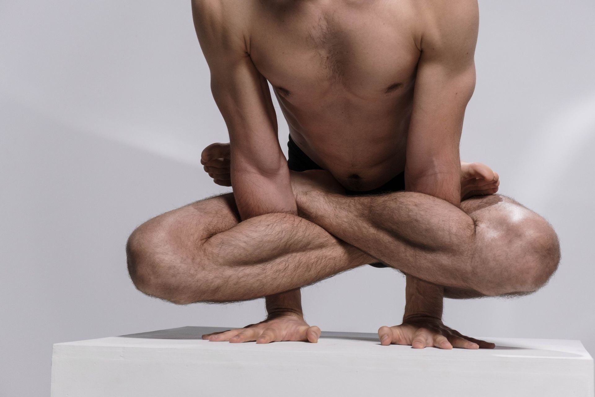 Yogi demonstrating lotus pose hand-balance
